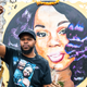 Breonna’s boyfriend, Kenneth Walker poses in front of her painted portrait on the One Year Anniversary of the death of Breonna Taylor on March 13, 2021 in Louisville, Kentucky.